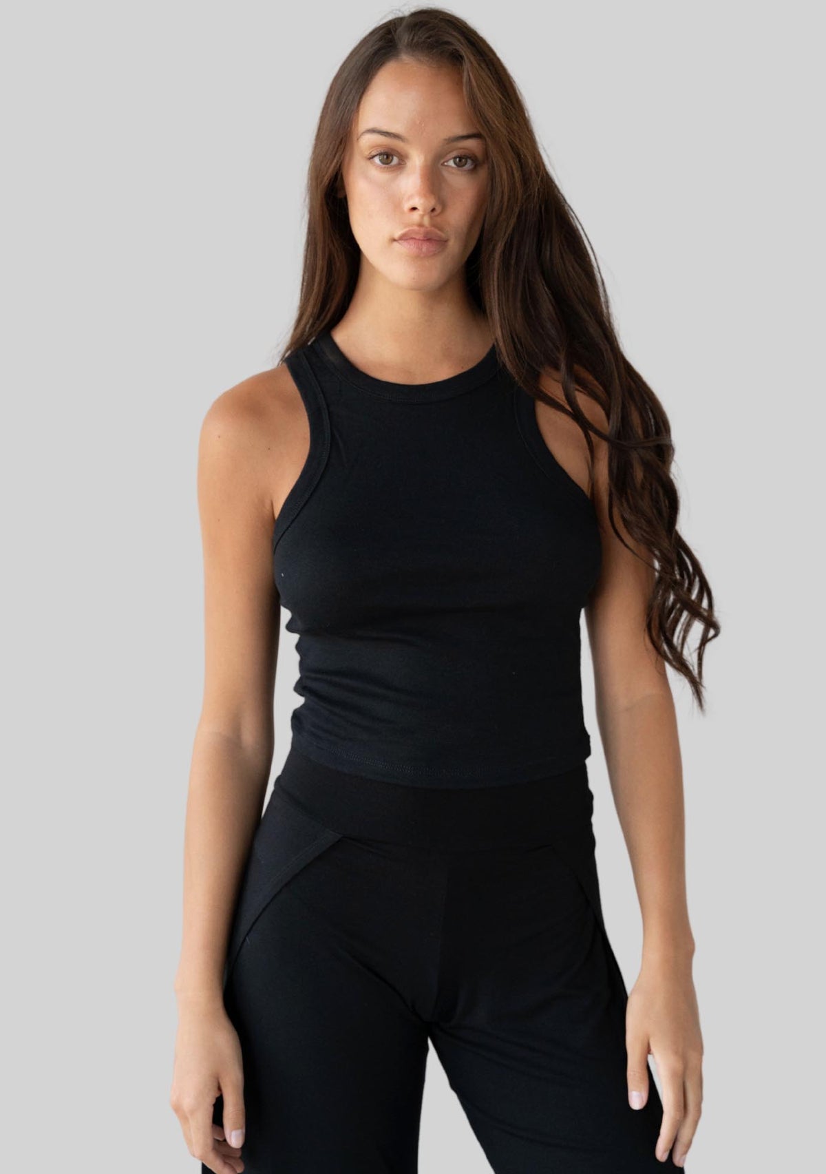 Jala Bliss Rib Tank in Black - model photo. [label] Amelia is 5'9" S